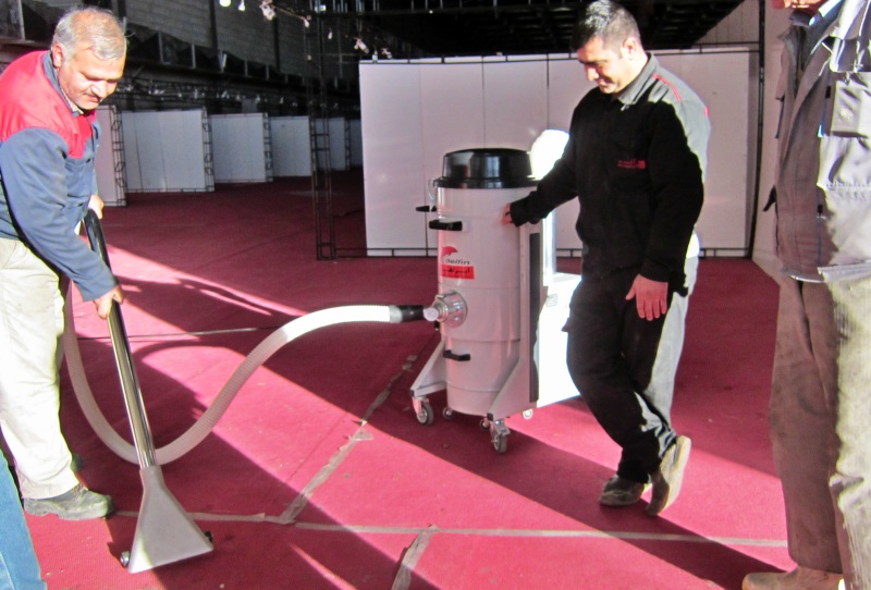 cleaning the carpet of exhibitions by vacuum cleaner